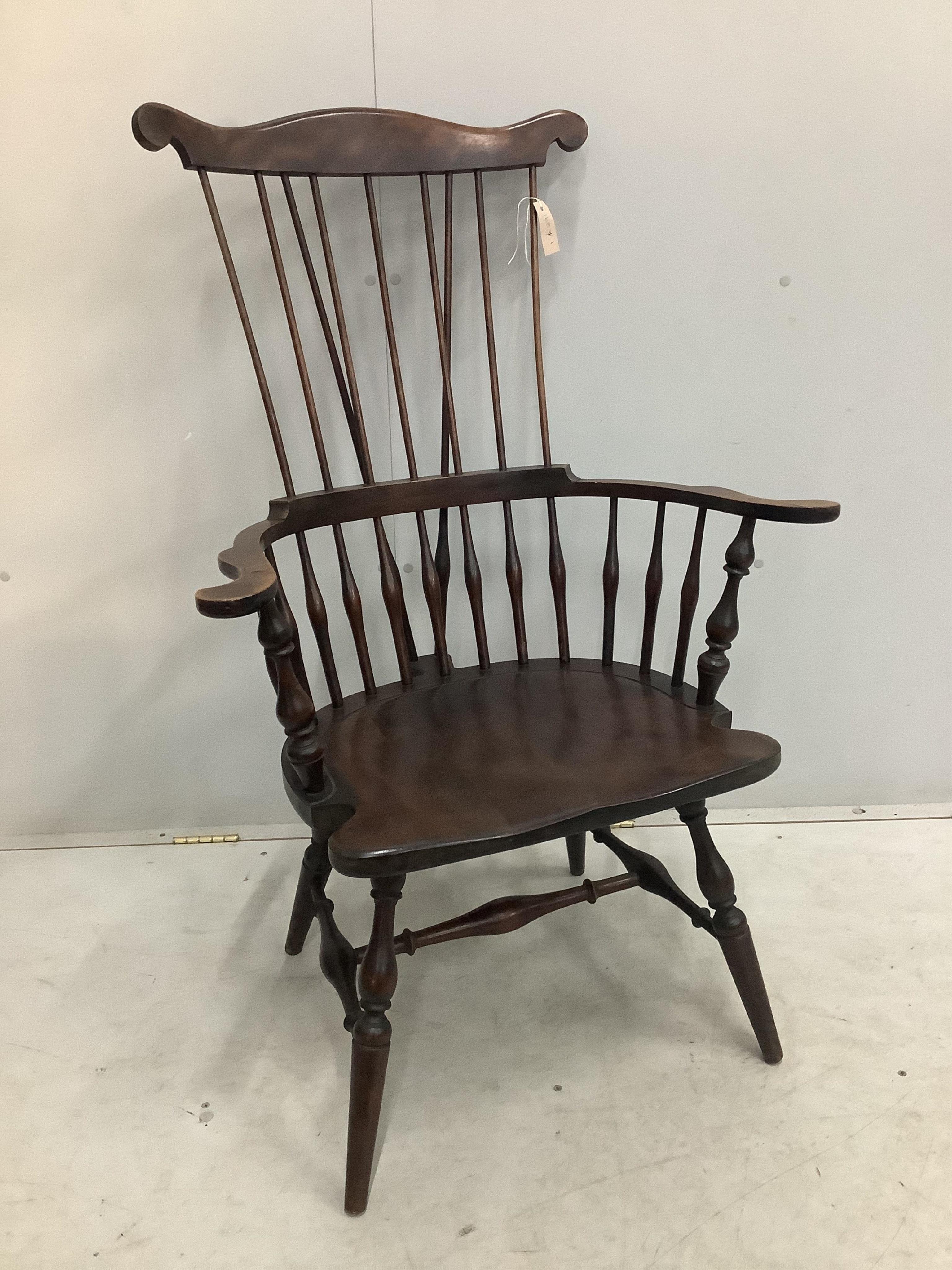 A 20th century American Windsor beech comb back armchair, width 73cm, depth 51cm, height 113cm. Condition - fair